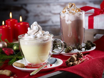 Two Artesano Hot and Cold Beverages coffee glasses with hot chocolate on a Christmas table.