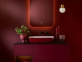 A bathroom with red walls and an Artis washbasin by Villeroy & Boch.