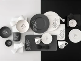 The entire Manufacture Mickey collection features black and white plates, cups and bowls on a split black and white background.
