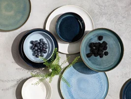 Various Crafted pieces with blueberries or blackberries, artfully arranged on a textured surface.