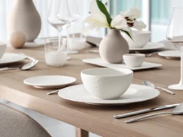 Close-up of a bowl from the Manufacture Blanc collection styled within a full white tablesetting, highlighting the porcelain texture and clean modern design.