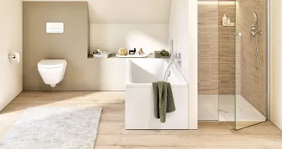 Architectura bath with a green towel An Architectura bath in a light Scandi-look bathroom with a green towel draped over the bath.