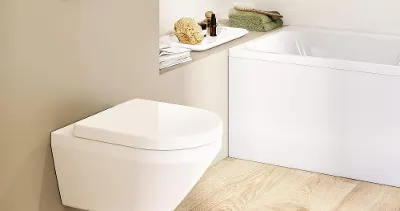 A white Architectura toilet with a flush plate in a Scandi-look beige bathroom