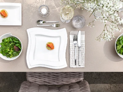 Ein gedeckter Tisch mit NewWave-Tellern und -Besteck von Villeroy & Boch.