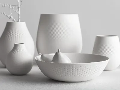 A detailed close-up of Manufacture Blanc Collier vases in various shapes and sizes, highlighting their fine texture and elegant matte finish.