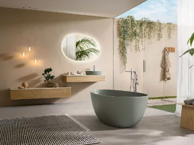 Un bagno moderno con vasca verde della collezione Antao e mobili in legno coordinati.