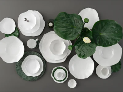 Vaisselle blanche de la collection Pura sur un fond sombre décoré de grandes feuilles vertes et d'une seule fleur blanche.