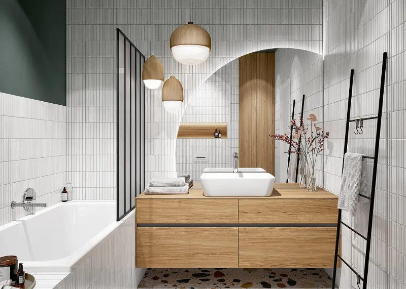 Interno di un bagno moderno e luminoso con pavimento in battuto di terrazzo, piastrelle bianche, armadietti in legno, vasca da bagno di Villeroy & Boch e piante decorative.