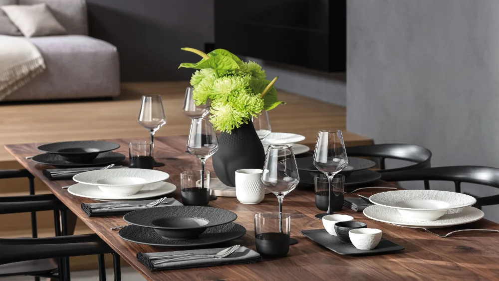 Stylishly set table with Manufacture dinnerware in black and white A stylishly set table with dinnerware from the Manufacture collection in black and white, complemented by a matching vase.