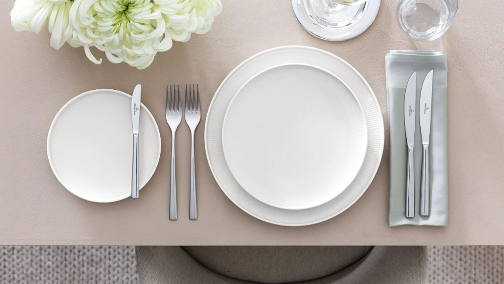A table set with Afina plates shown in a side view to see the floating effect of the plates.