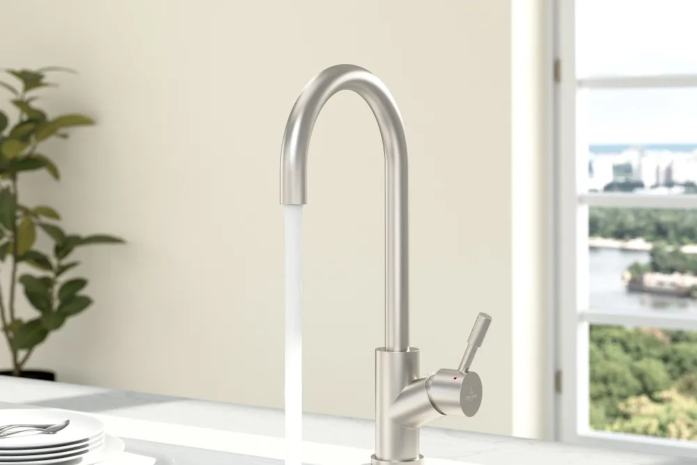 A stainless-steel Umbrella tap on a white sink with white plates on the draining board.