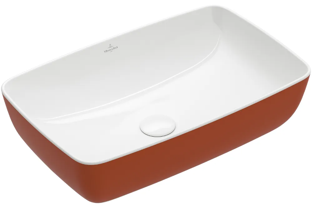 Rectangular white ceramic washbasin with an orange-coloured outer surface and a drain positioned in the centre.