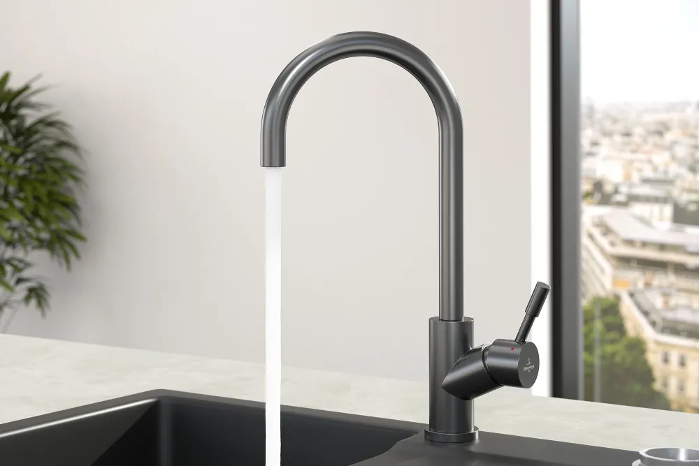 An anthracite Umbrella tap on a black sink with white plates on the draining board.