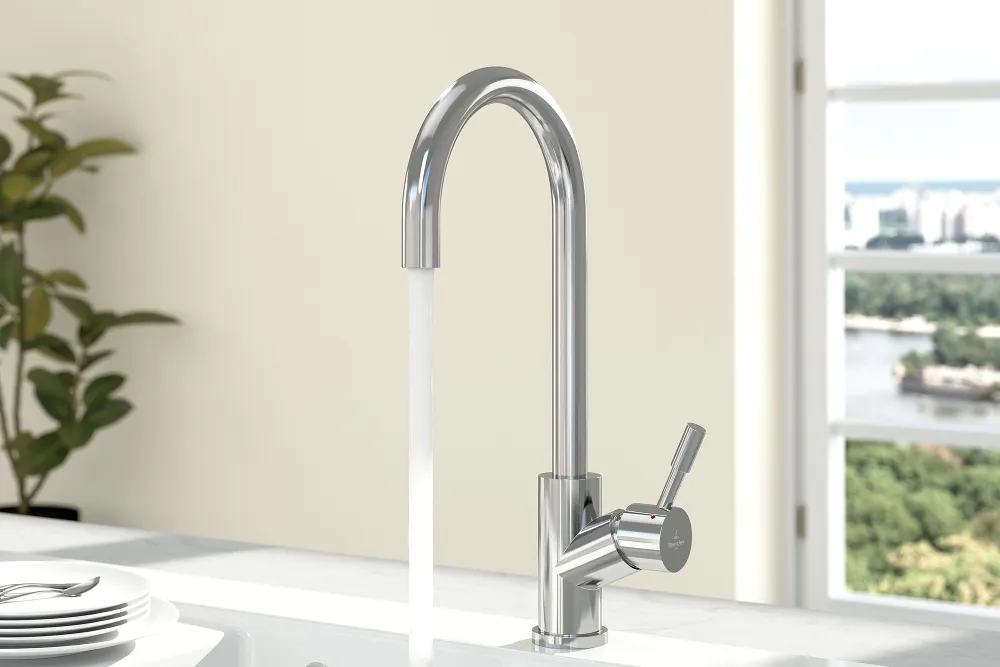 A polished stainless-steel Umbrella tap on a white sink with white plates on the draining board.