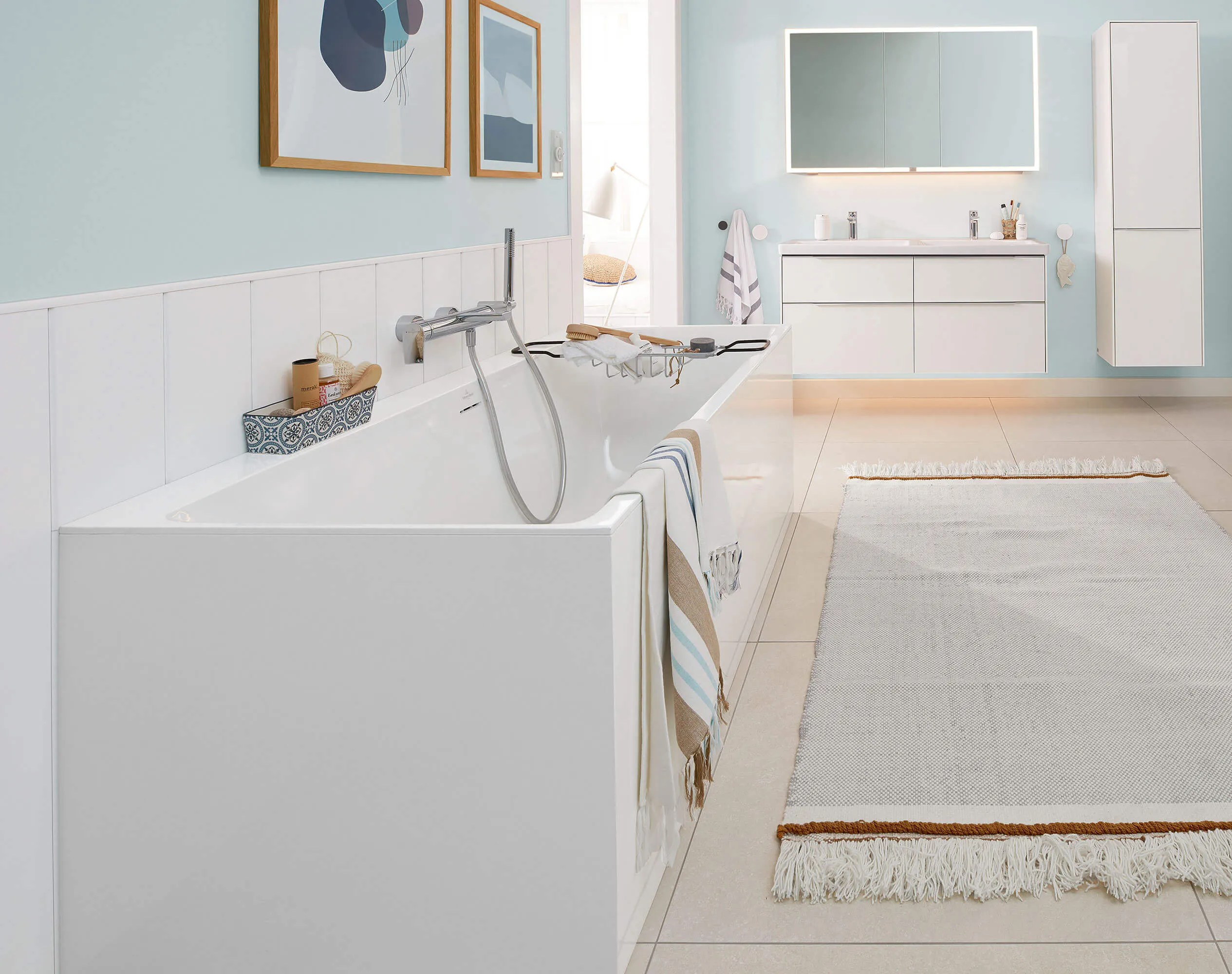 A white Subway 3.0 bath in a modern bathroom with blue walls.