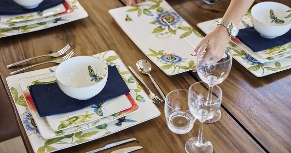 Amazonia Flat Plate and Serving Plate Indoor Table Setting Amazonia dinner set, arranged on a wooden table, with salad plate, buffet plate and individual bowl. Accented with blue linen napkin and silver cutlery, paired with Octavie glassware.