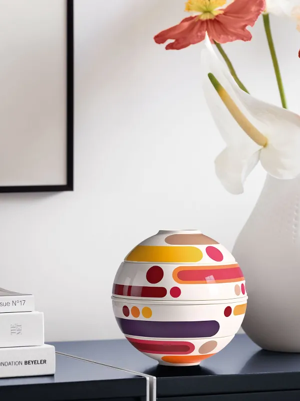 Decorative arrangement with La petite Boule Miami and a white vase on a light sideboard.