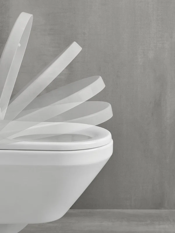 Toilette mit grauem Wandhintergrund, auf dem die Bewegung des Öffnens und Schließens des Deckels zu sehen ist.