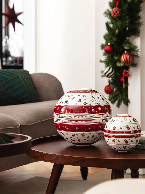 A living room decorated for Christmas with the Toy’s Delight La Boule and the Toy’s Delight La petite Boule on a wooden coffee table.