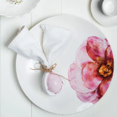 Rose Garden plate with a floral pattern and a bouquet of tulips Elegant table decoration with floral-patterned Rose Garden plates and a bouquet of tulips.