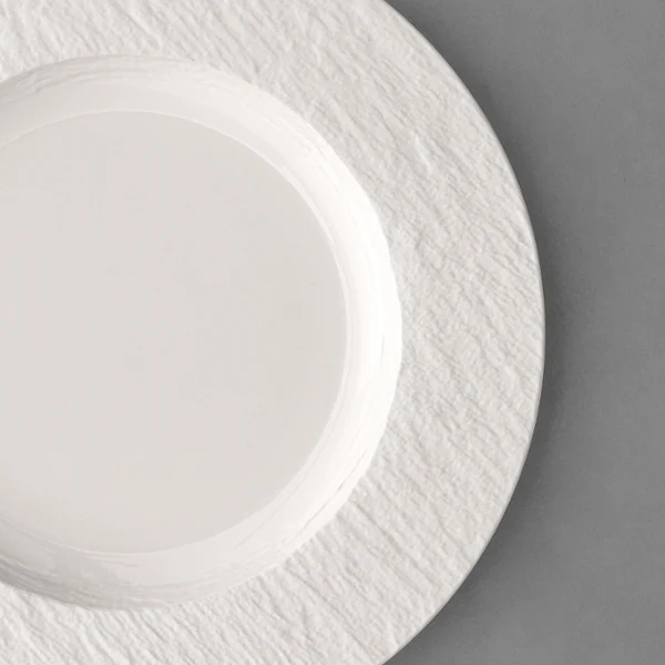 Manufacture plate Manufacture plate on a grey table.