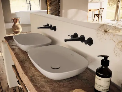 Lavabo Loop & Friends con rubinetteria Conum nera Interno bagno moderno con due lavabi ovali Loop & Friends su un piano in legno rustico, con rubinetti Conum nero opaco
