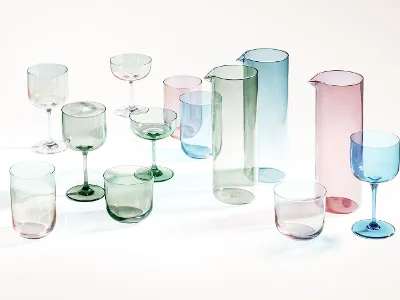 Translucent colored drinking vessels, such as jugs and goblets, are displayed on a white surface.