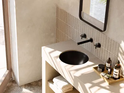 Sort Loop & Friends-håndvask i et moderne beige badeværelse Moderne badeværelse med beige håndvaskplade og sort Loop & Friends-håndvask. Tilbehør omfatter håndklæder og toiletartikler.