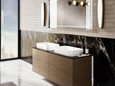 Lavabo doppio con grande specchio della collezione Finion Bagno moderno con doppio lavabo Finion, pavimento in marmo, accenti in marmo alle pareti, grande specchio e lampade a sospensione. Le finestre a tutta altezza mostrano un paesaggio urbano.