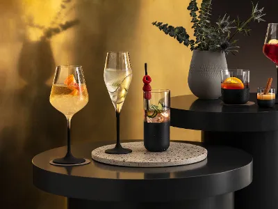 Various cocktails, elegantly presented in Manufacture glasses Various cocktails, elegantly presented in Manufacture glasses on a modern bar table with atmospheric lighting.
