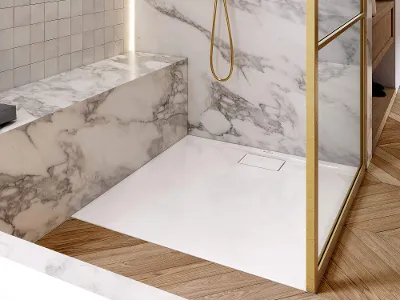 White, square shower tray from the Architectura collection in a bathroom with marble tiles. A square shower tray is in a bathroom tiled in marble look. It is framed by a glass pane with a golden border.