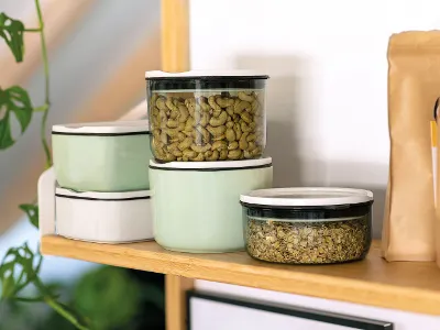 ToGo containers on a shelf ToGo containers from Villeroy & Boch are stacked next to a brown paper bag on a wooden shelf.