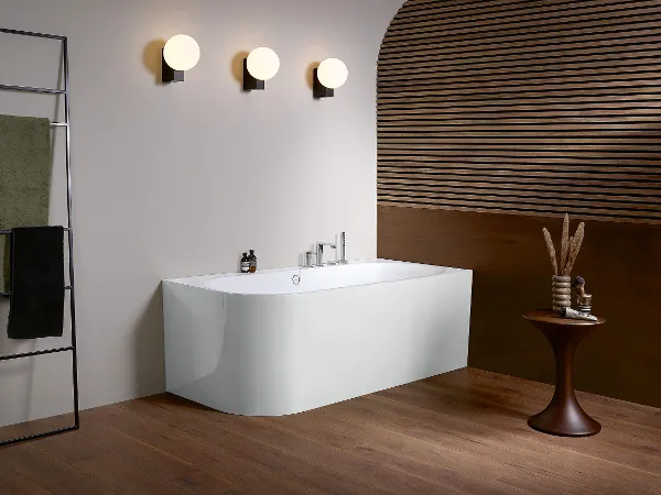 Oberon bath in a modern bathroom A modern bathroom with a wooden floor and wooden walls, and an Oberon bath by Villeroy & Boch.