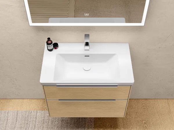 White Subway 3.0 washbasin with a brown base unit A white Subway 3.0 bathroom washbasin with a brown vanity unit and tap.