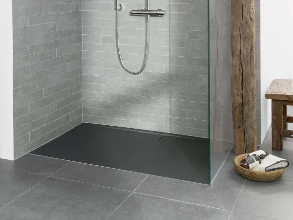 Grey Architectura shower tray with grey tiles Modern walk-in shower with a glass partition and grey tiles