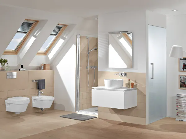Architectura bathroom with a white toilet and bidet and a coordinating washbasin with a mirror Modern bathroom with a wall-mounted Architectura toilet and bidet, a floating washstand with a washbasin and a mirror, a glazed shower, a skylight and a lamp.