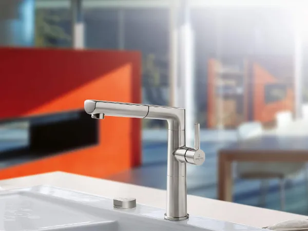 Sorano Sky Shower kitchen tap on a sink Modern kitchen tap on a white sink with a blurred interior background that showcases elegant design elements.