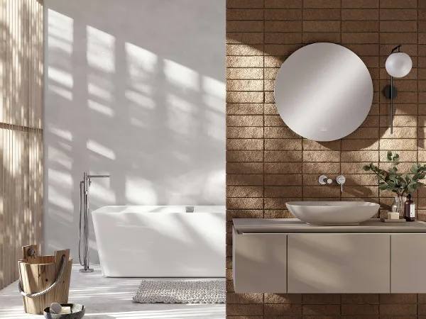 Modernes Badezimmer mit weißer Loop & Friends-Badewanne von Villeroy & Boch Modernes Badezimmer mit weißer Loop & Friends Badewanne von Villeroy & Boch, rundem Spiegel über einem beigen Waschbecken, Holzhocker und Ziegelstein-Akzentwand.