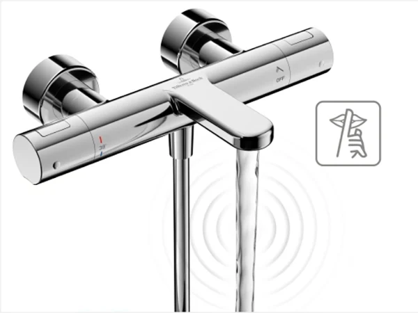 Wall-mounted chrome faucet with two rotary knobs, with water flowing from it and a square on/off symbol on the right side.