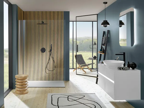 Universal Showers shower tap with washbasin Black Universal Showers shower tap in a petrol-coloured bathroom with large windows and a washstand.