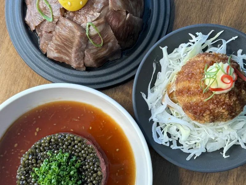 Chef Alex Trim presents: Wagyu Beef with egg yolk, katsu arancini on cabbage, and tartare with caviar sauce.
