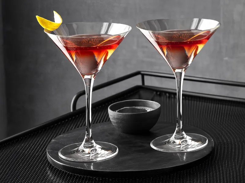 Purismo Martini glasses placed on a black bar cart.