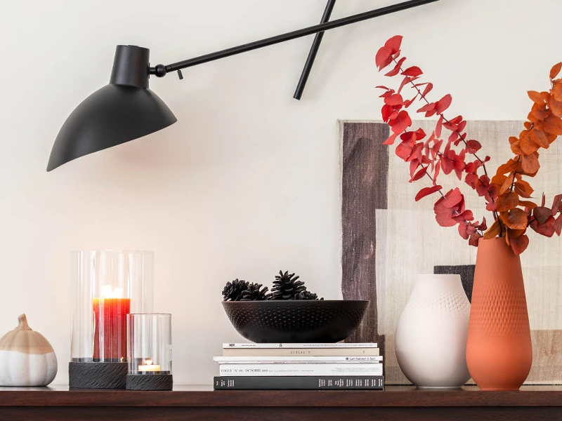 Modern sideboard with Manufacture decorative items and an adjustable sconce.