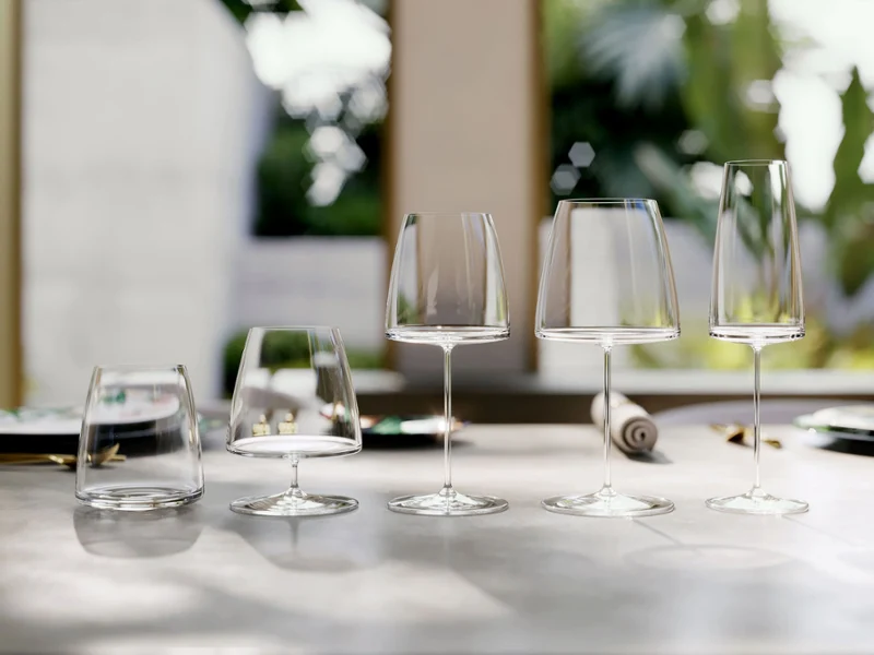 Various MetroChic glasses elegantly arranged on a light-coloured table MetroChic glasses elegantly arranged on a polished table, with a blurred garden in the background.