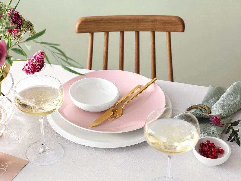 Elegant dining table decoration with Rose Garden and New Moon dinnerware, floral centerpiece and golden MetroChic flatware.