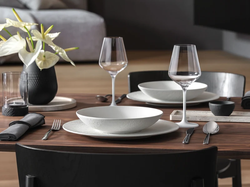 A curated set featuring Manufacture Rock, Collier Vase, Travertine, Noir lantern and candle holder in an elegant, modern Table Set arrangement.