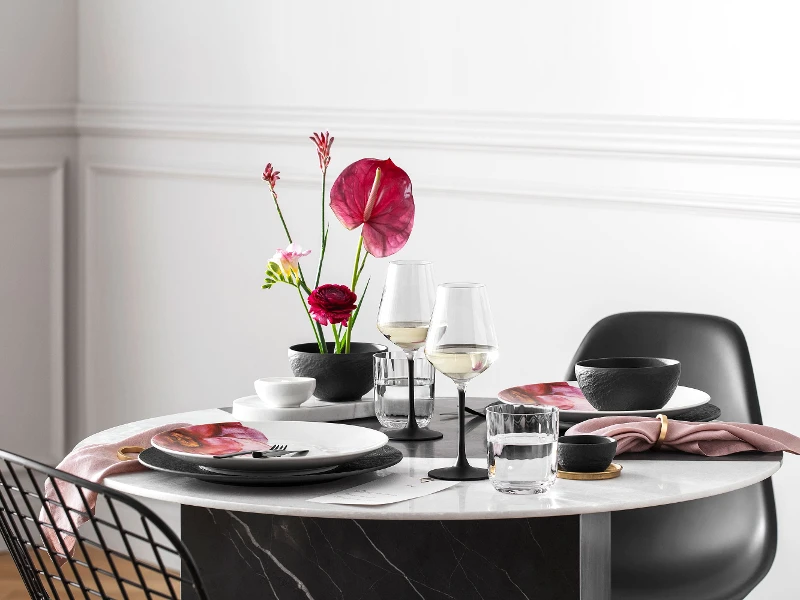 A dining table set for two with NewMoon, Manufacture and Rose Garden dinnerware from Villeroy & Boch.