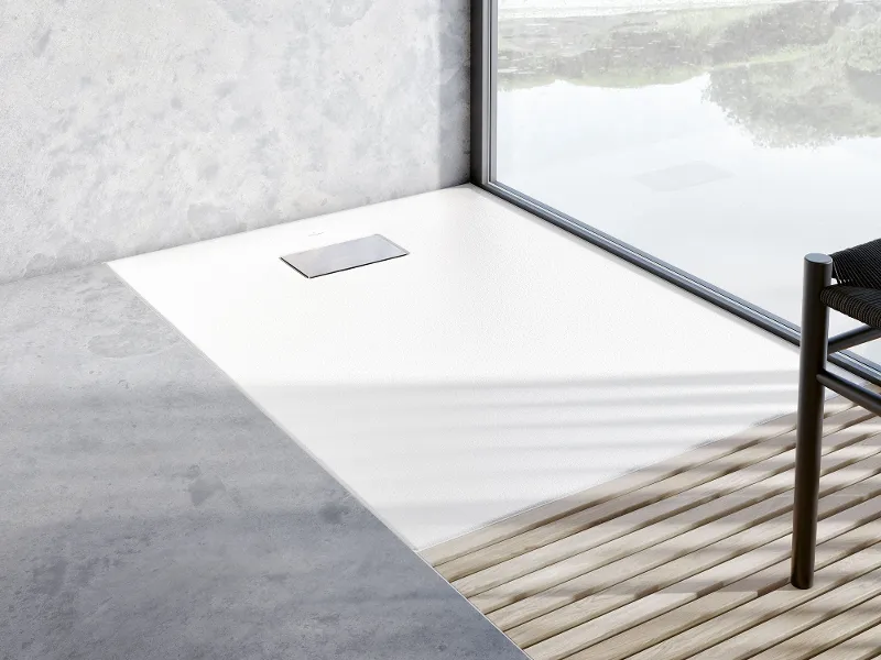 Primo piano di un piatto doccia Le Valence bianco e senza bordi in un moderno bagno Villeroy & Boch con rivestimenti in legno.