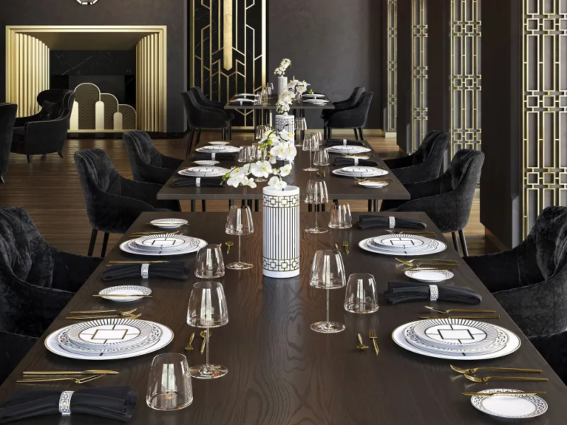 MetroChic crockery surrounded by dark velvet chairs with gold accents and a striking chandelier.