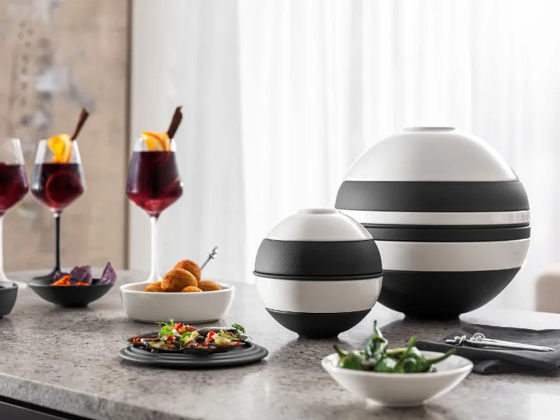 A dining table with appetizers served, arranged in La petite Boule next to the La Boule and Manufacture wine glasses.
